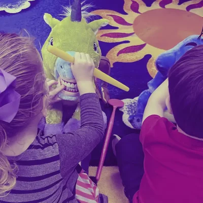 on-the-round-blue-learning-rug-playing-dentist-with-stuffed-animals